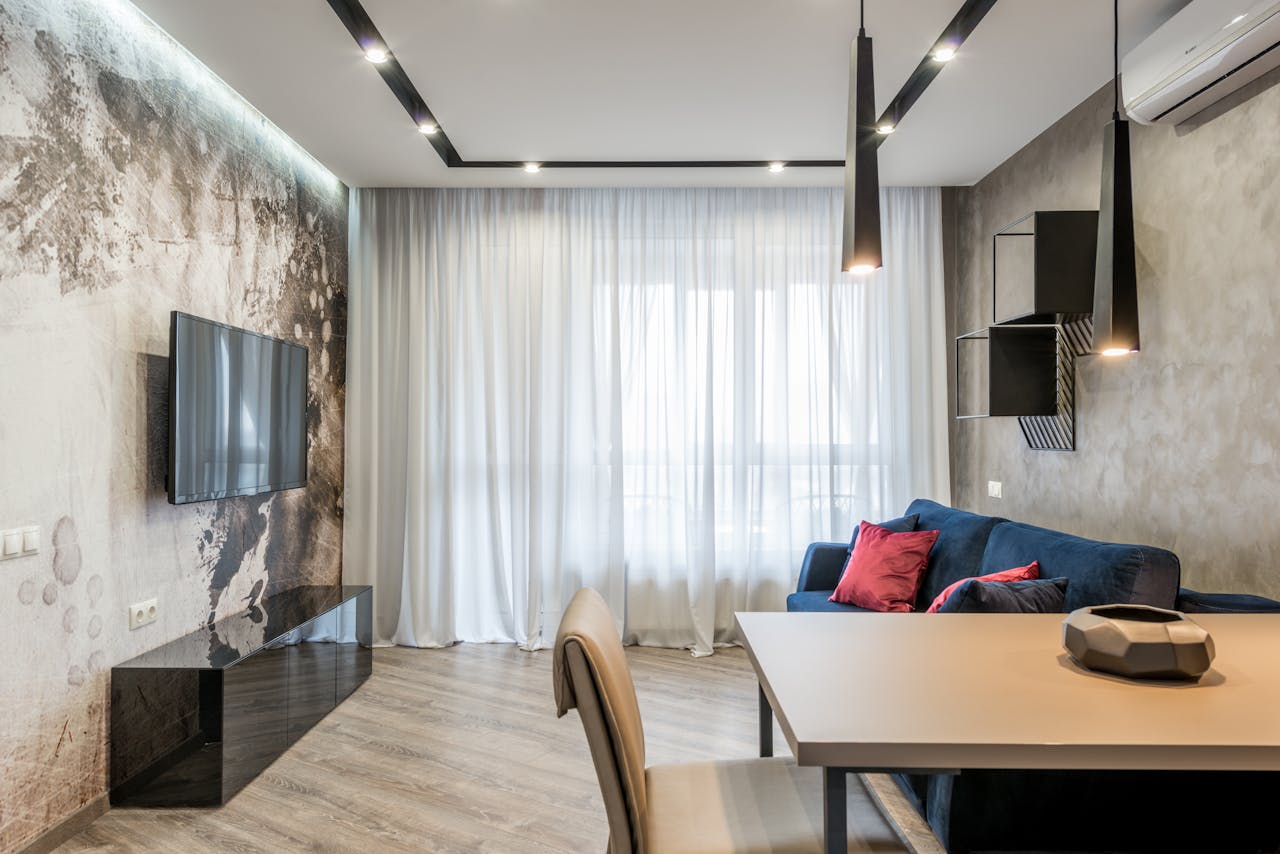 Stylish modern living room with minimalist decor, featuring a sleek sofa and elegant lighting.